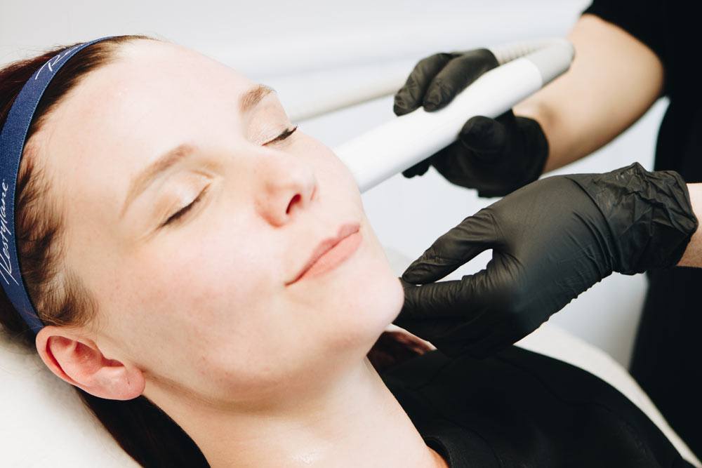 woman having Hydra facial / Glow Facial treatment on her face
