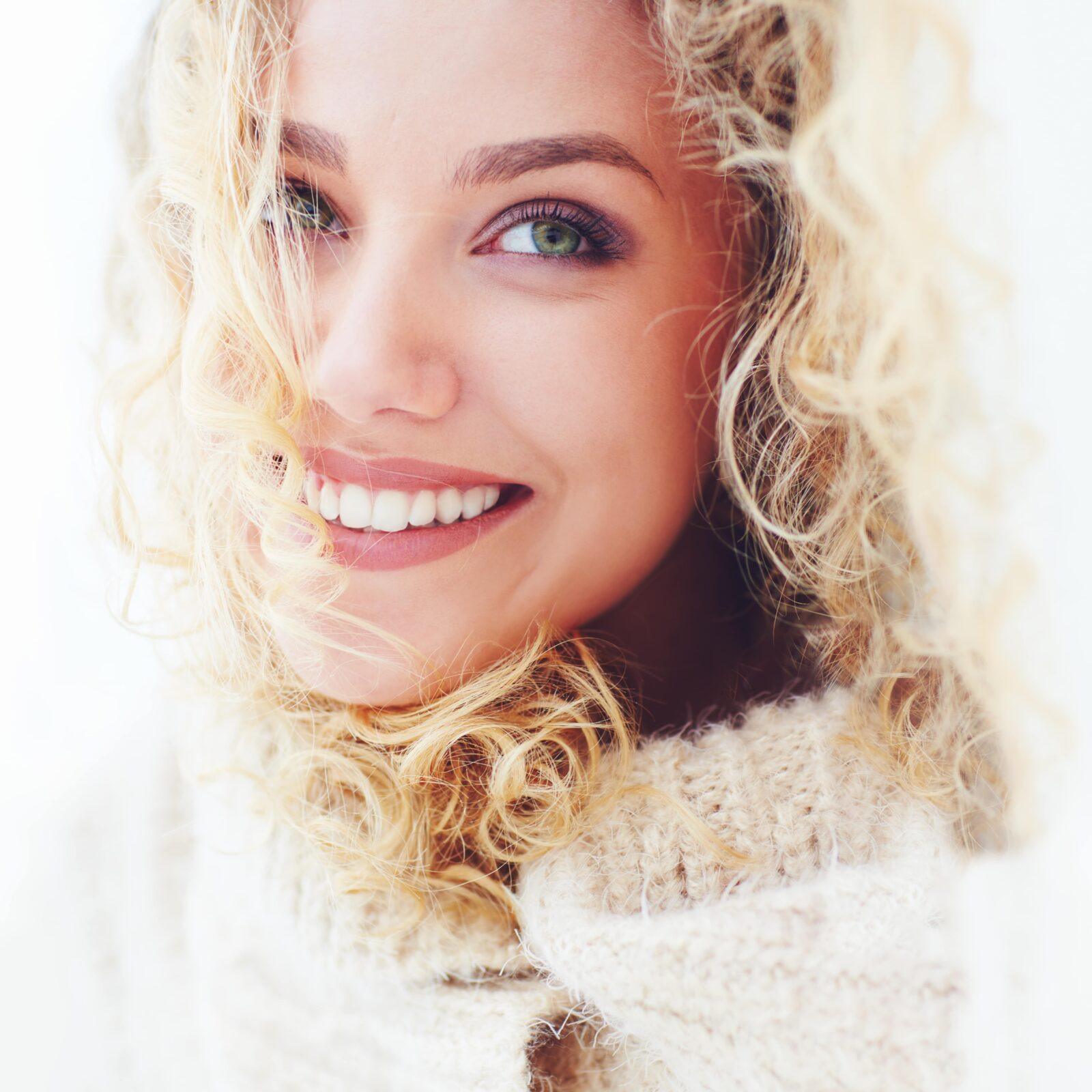 smiling blonde wearing a sweater