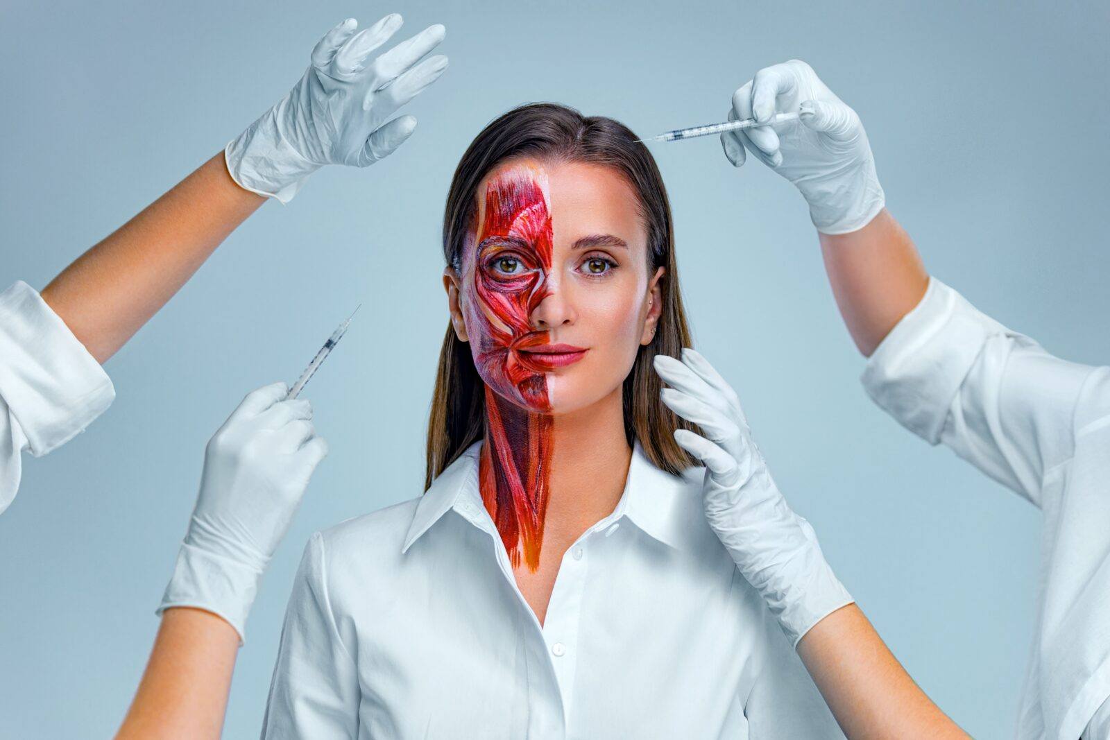 woman having facial injections with one side of her face showing underlying anatomy